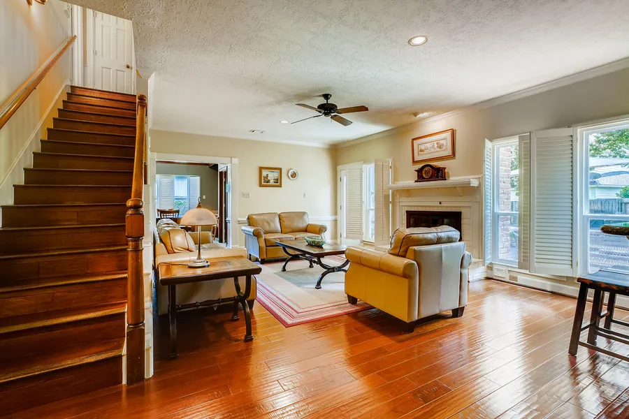 Living room with a staircase and hardwood floors